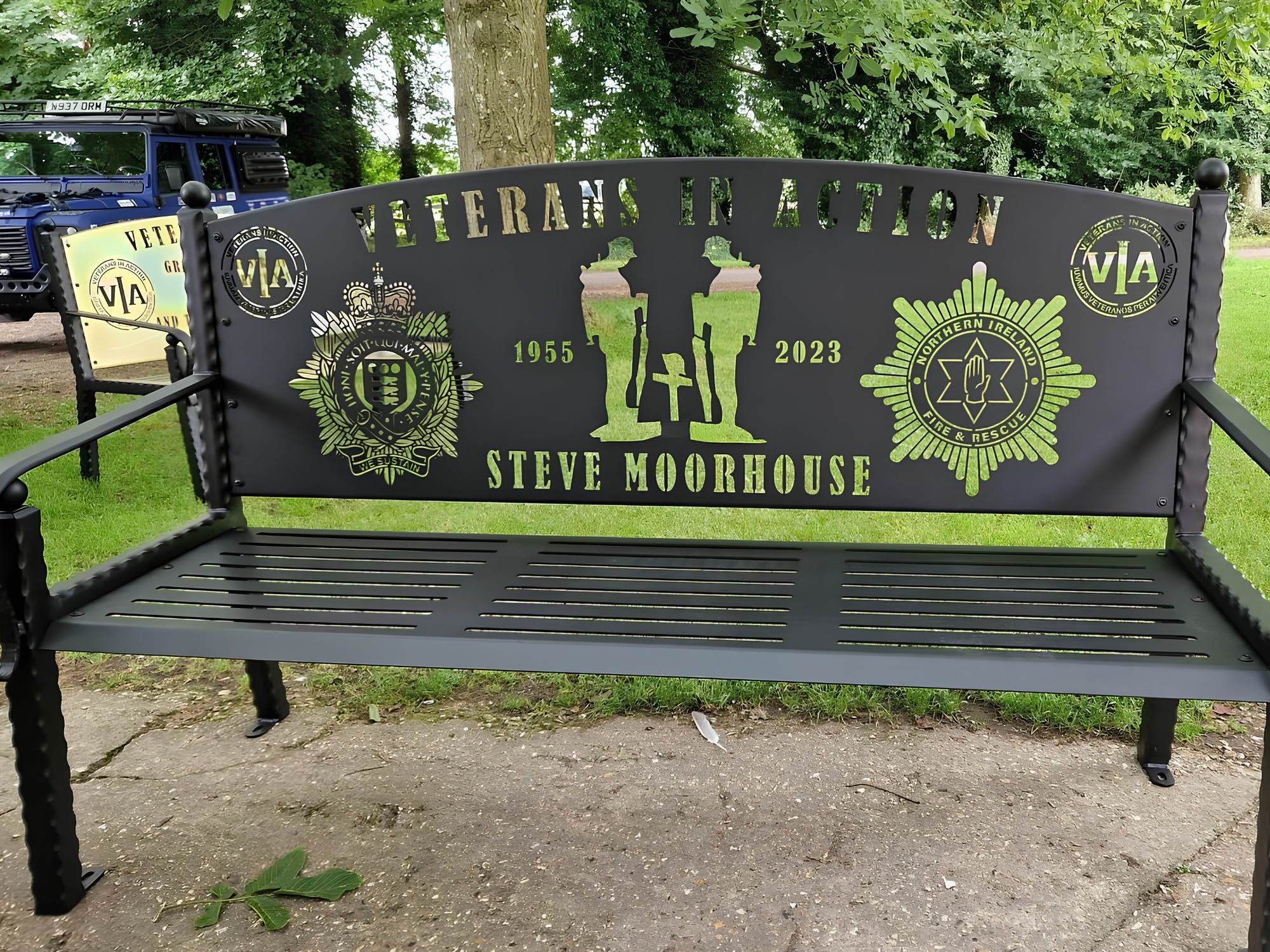 Veterans In Action memorial steel bench with laser‑cut soldier and crest design outdoors