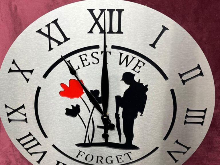 Lest We Forget remembrance clock with soldier silhouette and poppy design