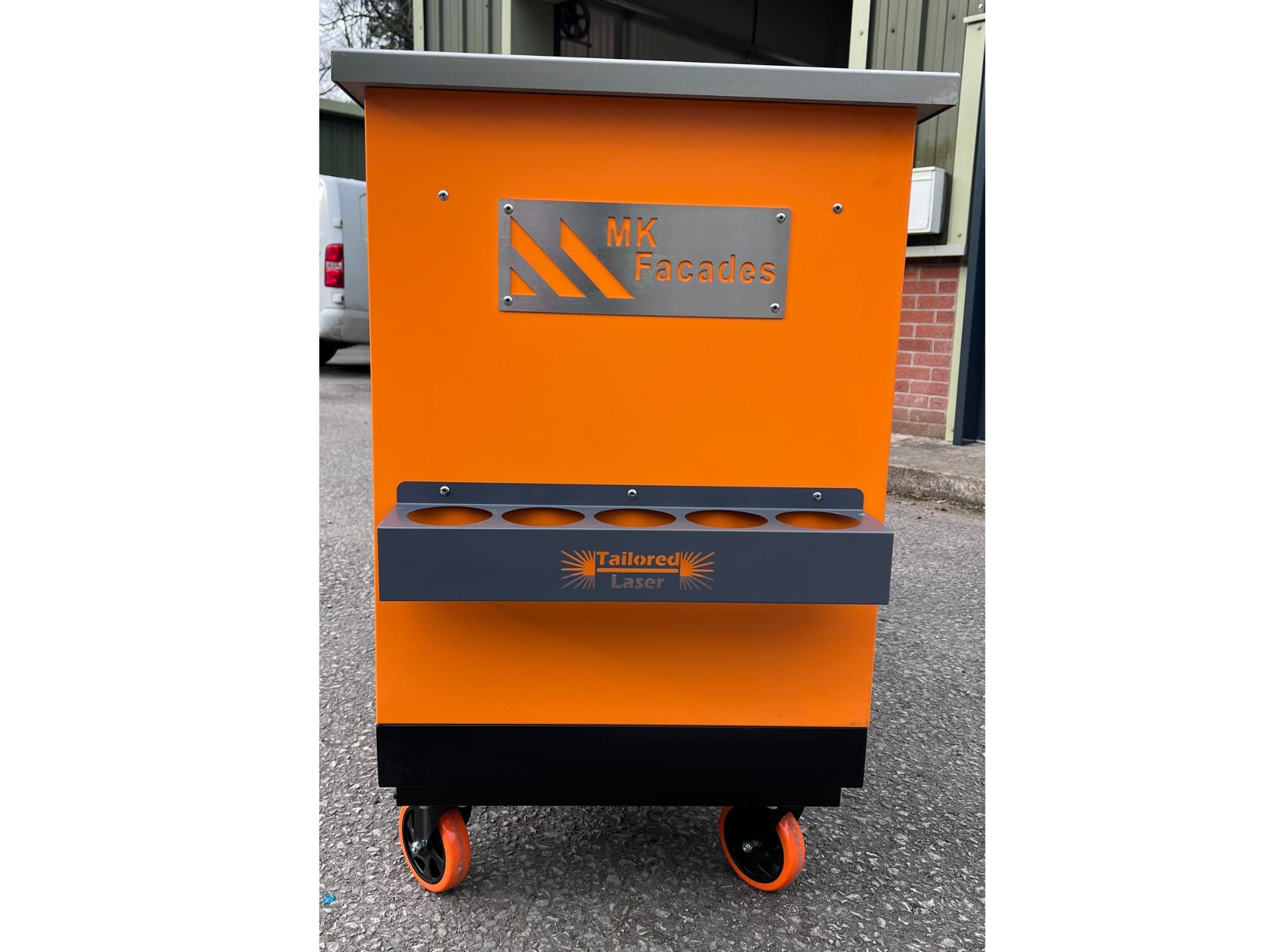 Orange mobile workshop unit with MK Facades and Tailored Laser branding and tool holders