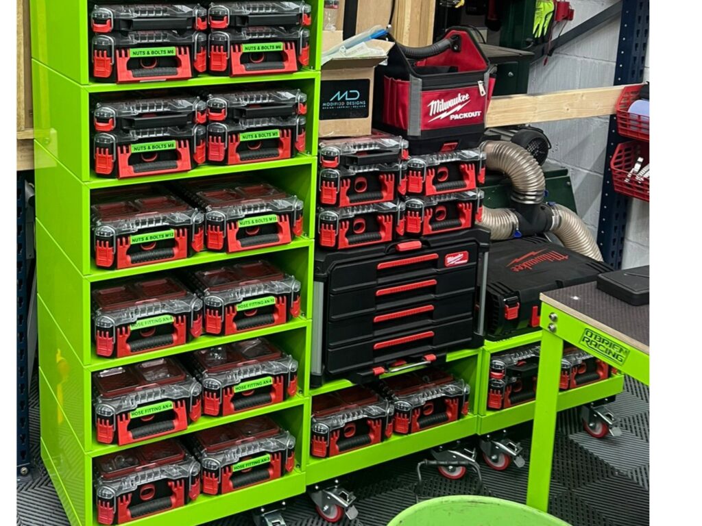 Motorsport workshop shelving with Milwaukee Packout tool boxes and labelled hardware containers